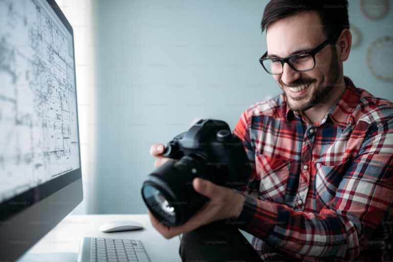 happy photographer checking camera photos